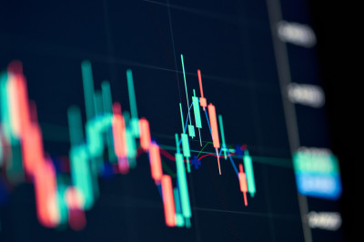 Stock market graph on screen.