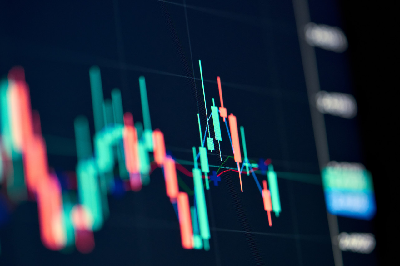 Stock market graph on screen.